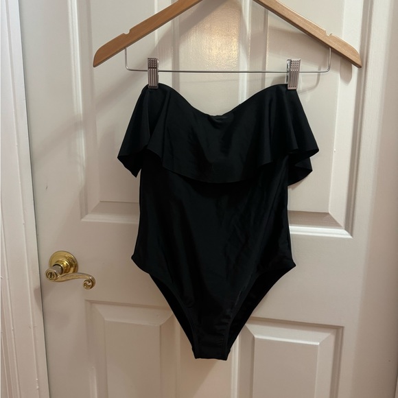 RAISINS Other - NWT RAISINS  Black one piece with Ruffle. JRs Size Small /Petite. New very chic